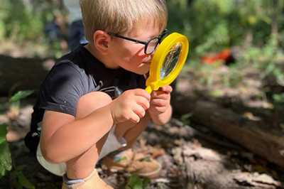 Preschooler using magnifying glass